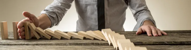 Man stopping domino's from falling