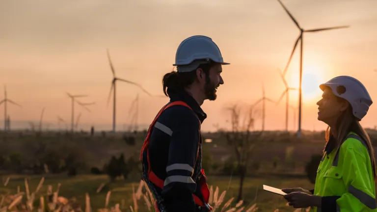 two wind farm engineers in foreground